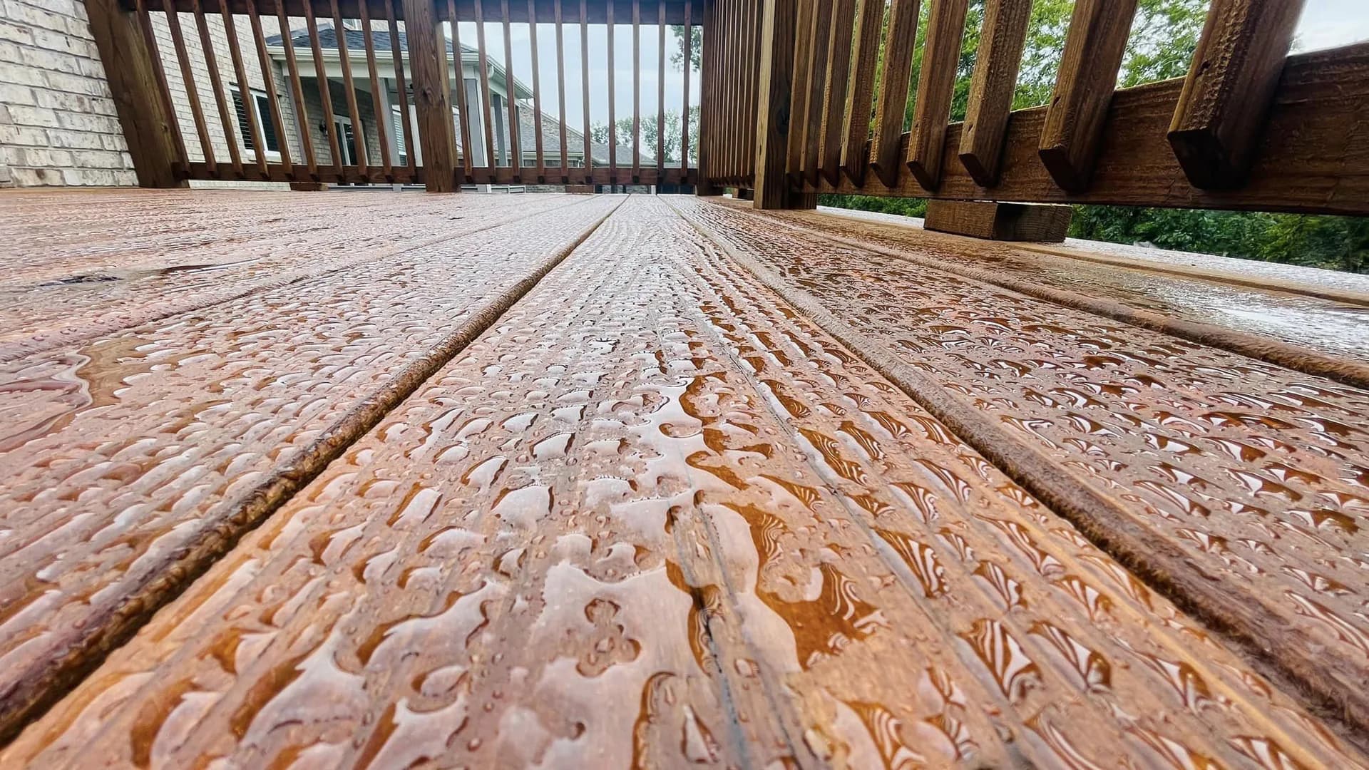 Rain beading on a deck finished with EXPERT Stain & Seal in Pecan