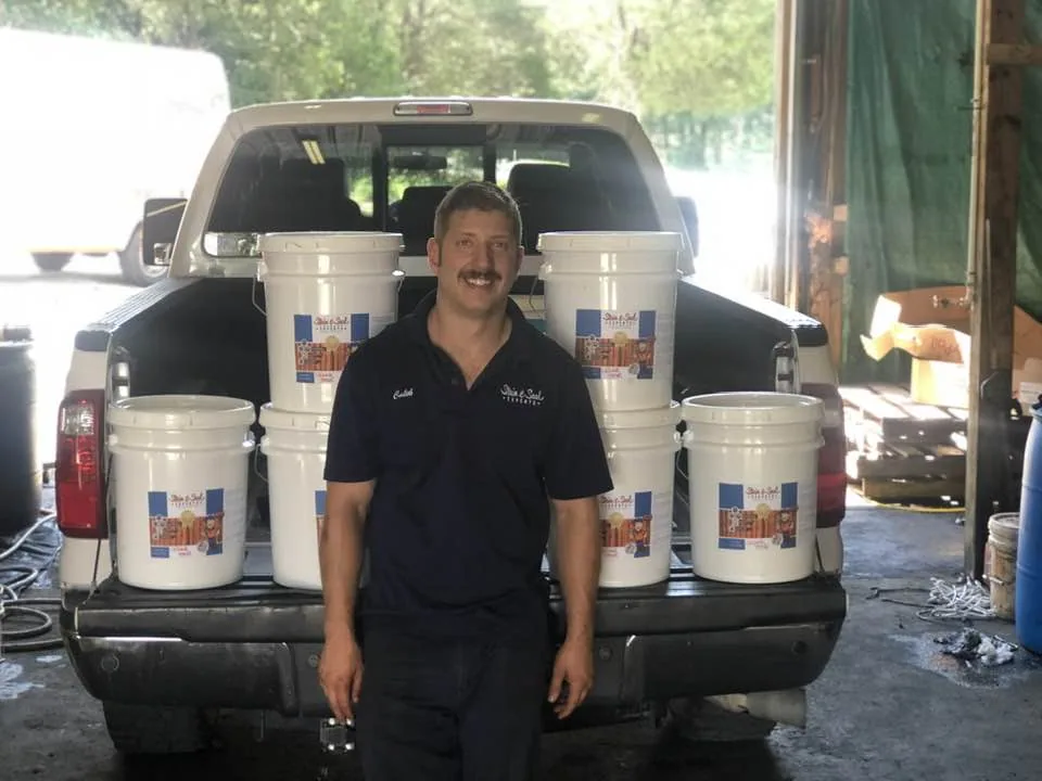 The first batch of Stain & Seal Experts Fence & Deck Stain loaded in a pickup