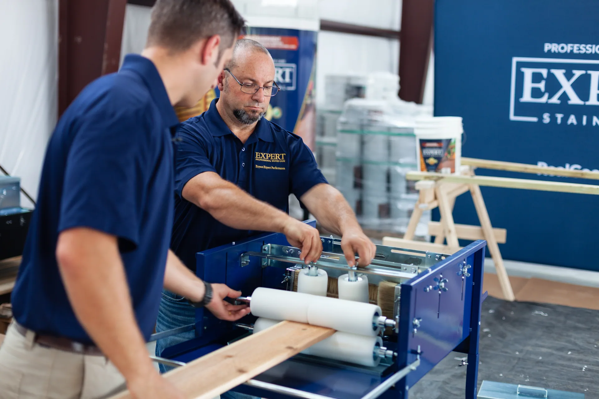 The EXPERT Paint & Stain Machine finishing a board