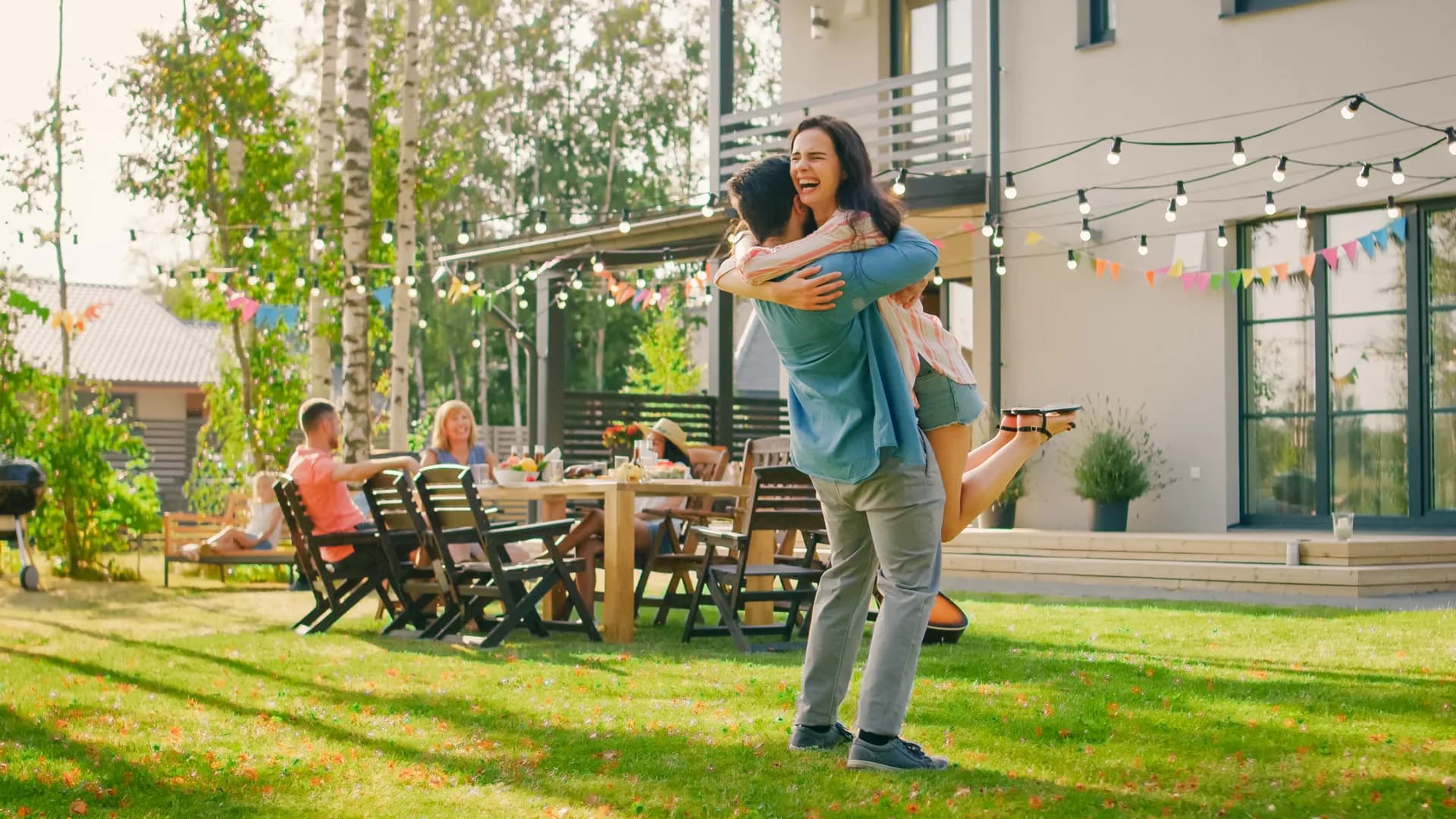 Family playing catch in a backyard cared for by Stain & Seal Experts