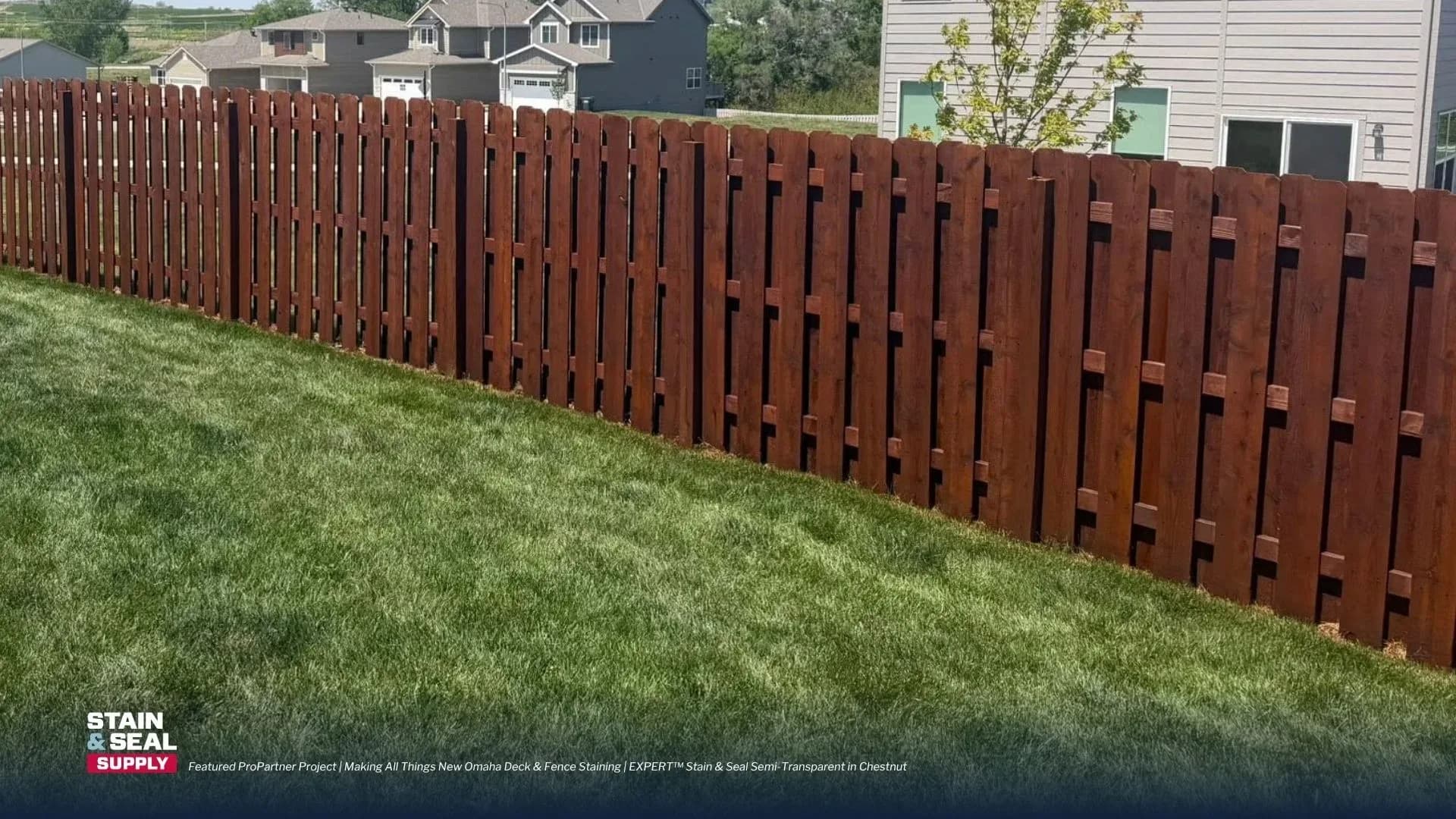 Freshly stained board-on-board privacy fence