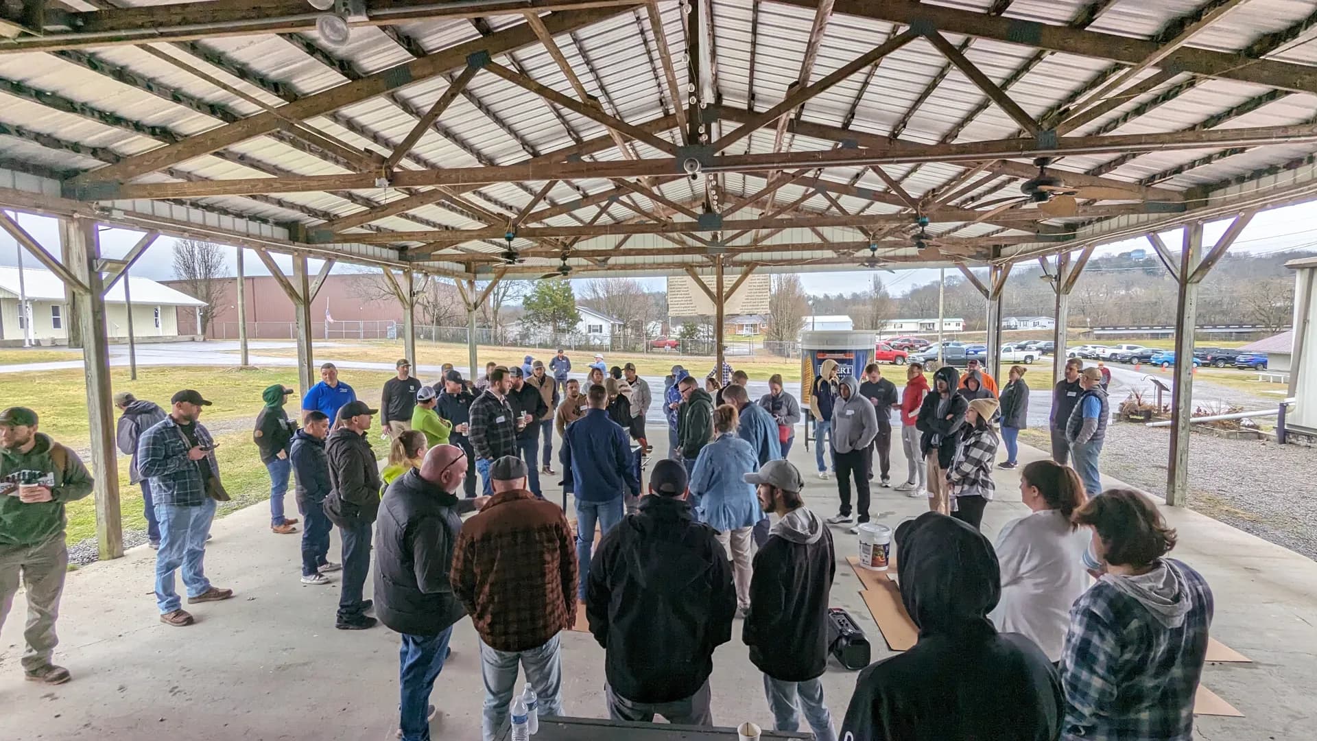 Contractors gathered under a pavilion at Staining University