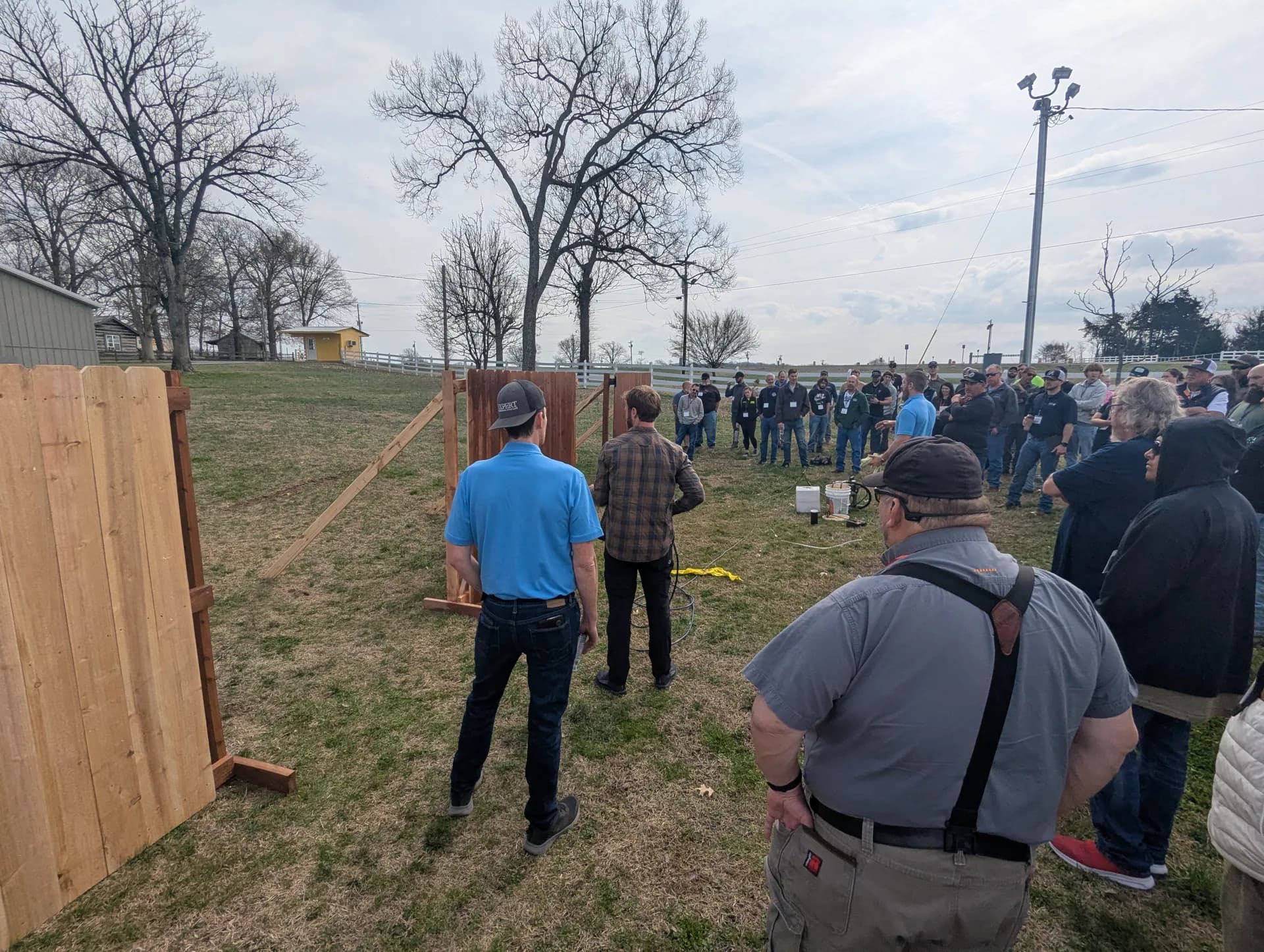 Instructor walking new contractors through a fence staining demo