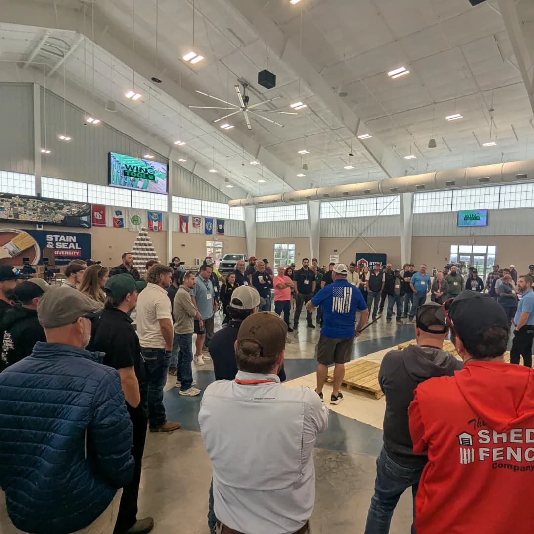 Contractors circled around a live session in the main hall at Staining University